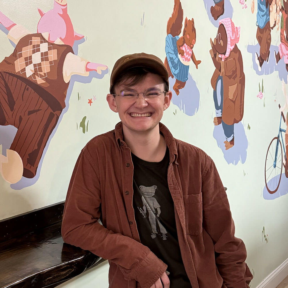 Artist posing with Art Scrim installation